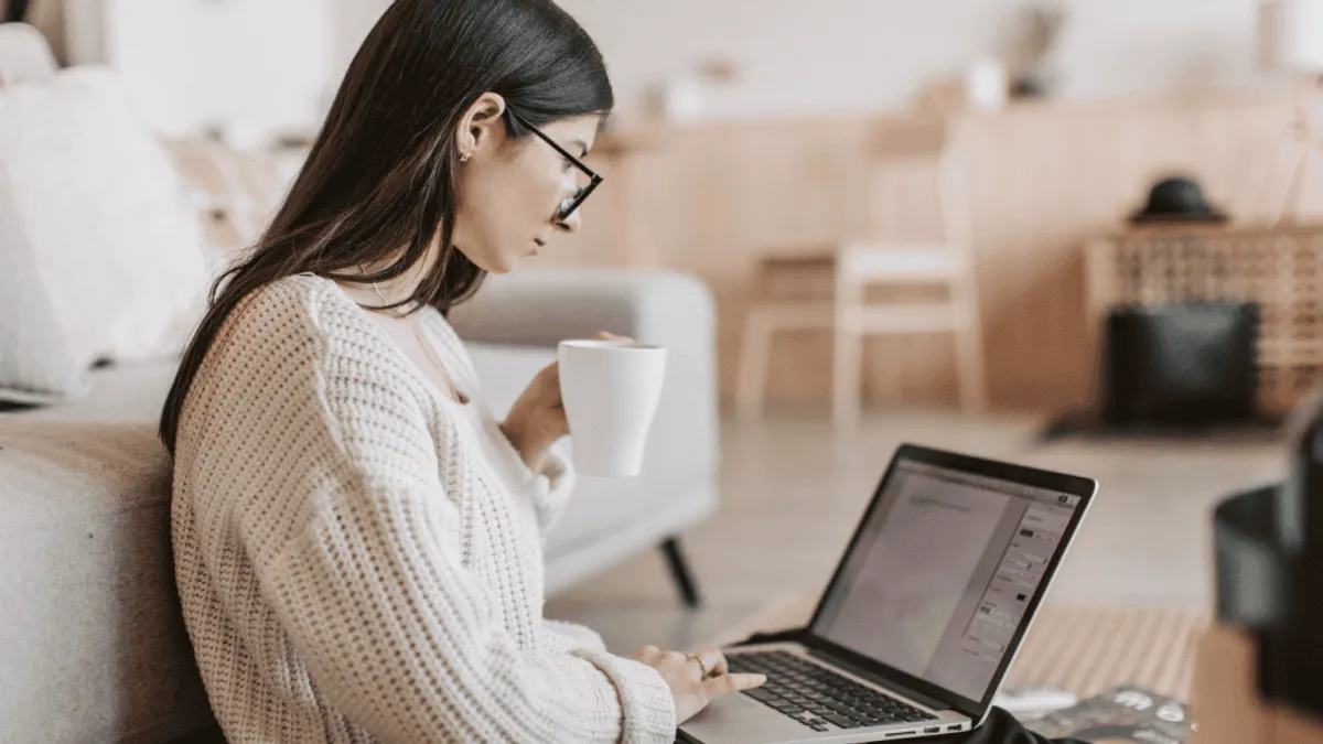 A writer using an AI model in front of a blank page aiming to create high quality content