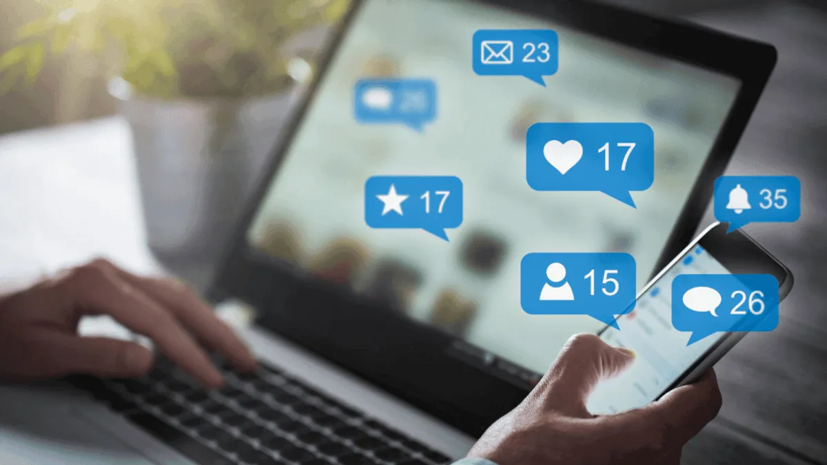 A person using a laptop to access various social media platforms