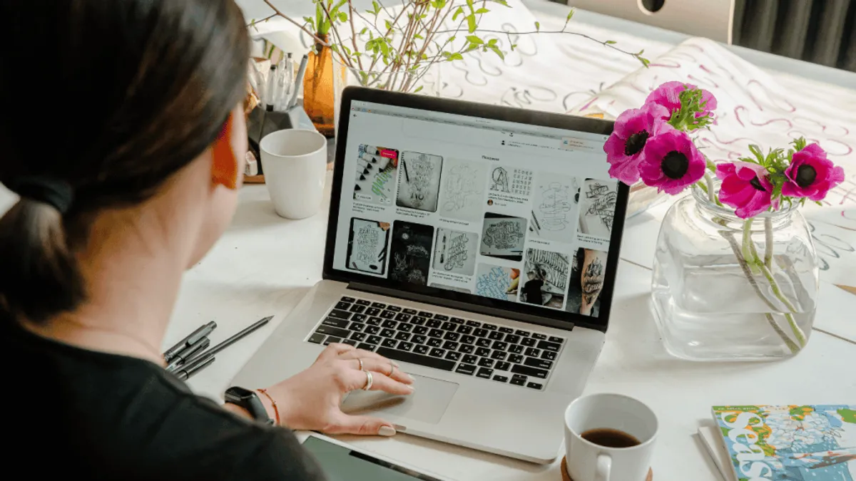 A person using a laptop to create digital artwork with an ai image generator