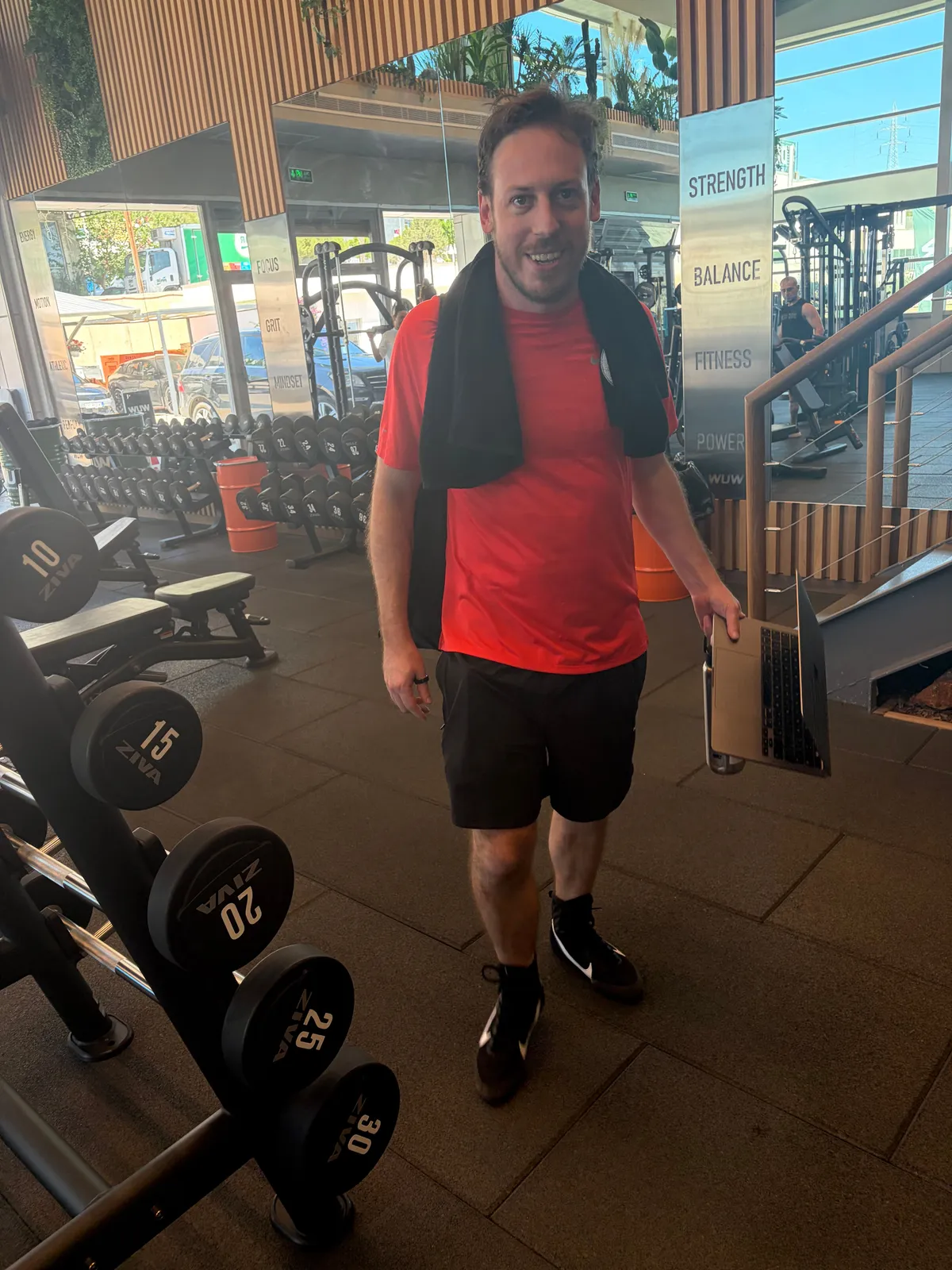 Tim at the gym with his laptop left open because Claude is working in the background