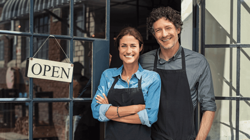 A small business owners in front of their business
