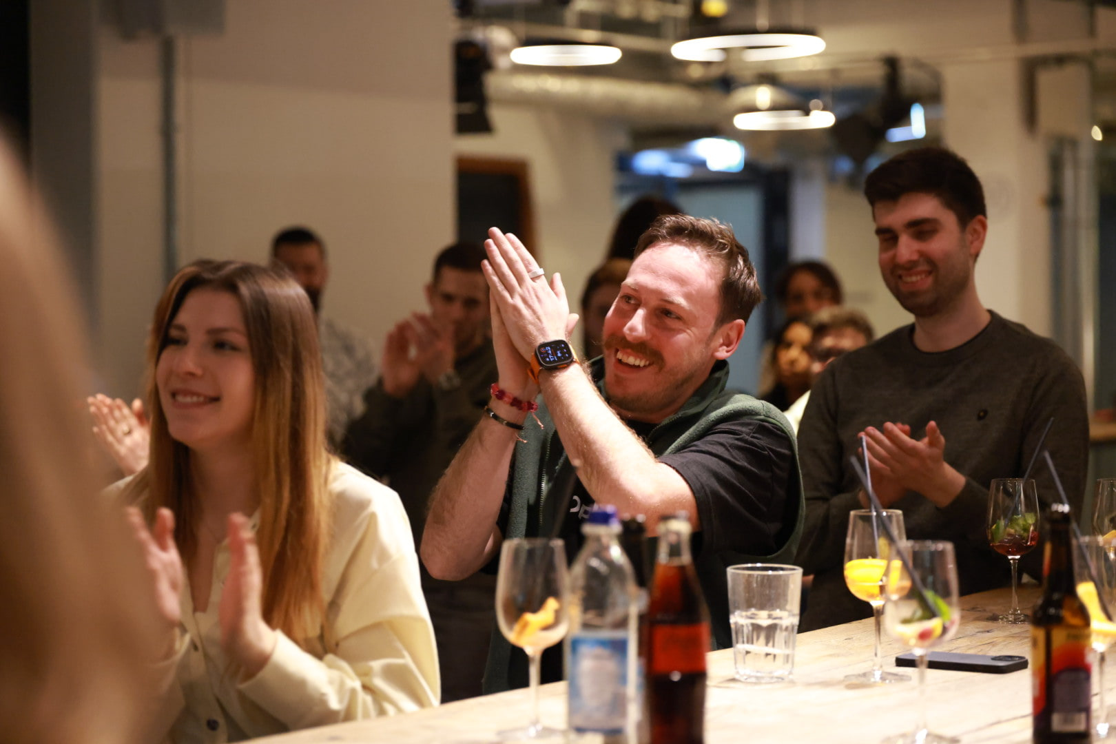 Client team members applauding and smiling at the end of a session at an AI Operator client kick-off in Munich.